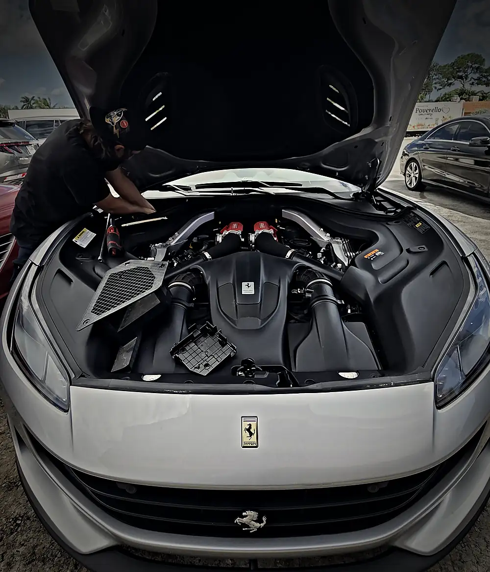 Ferrari Portofino front with the hood open and a technician working in the Prestige lot