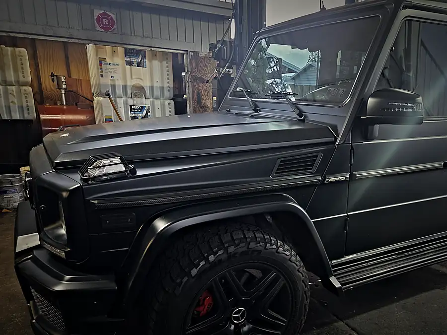 Matte black Mercedes-AMG G63 side view in the Prestige bay