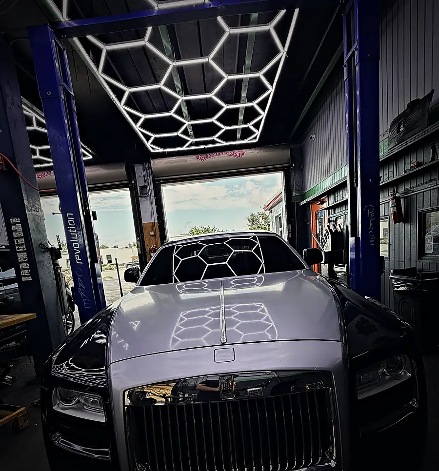 Front of a Rolls-Royce Ghost in a Prestige service bay, portrait view