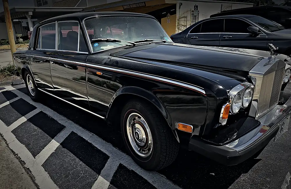 Classic black Rolls-Royce Silver Shadow parked in the Prestige lot
